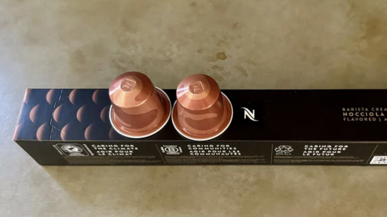 Nocciola Nespresso pods balanced on their packaging