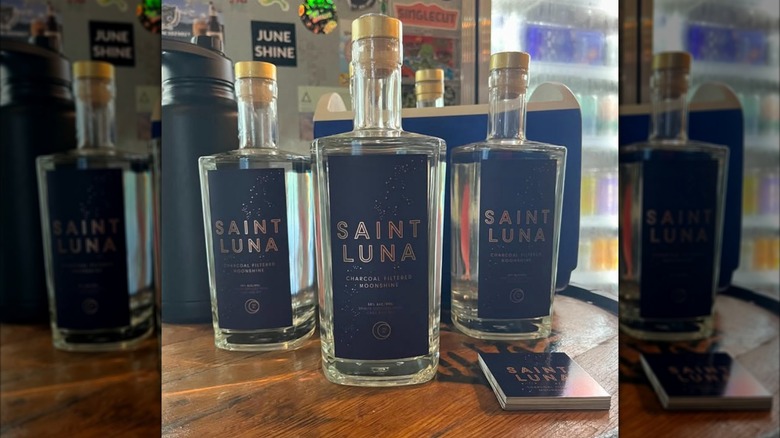 Three Saint Luna bottles on a table