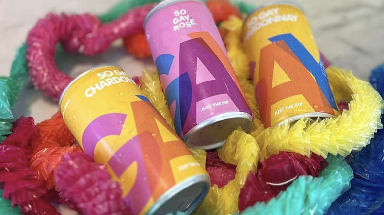 Three canned drinks and colorful streamers