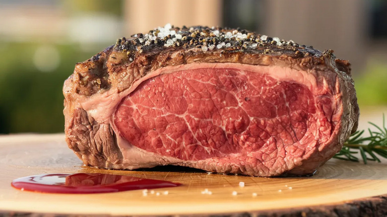 A piece of prime rib with a pink center and salt crusted exterior