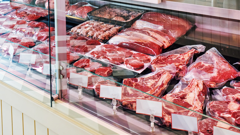 A butcher counter with a variety of raw meats