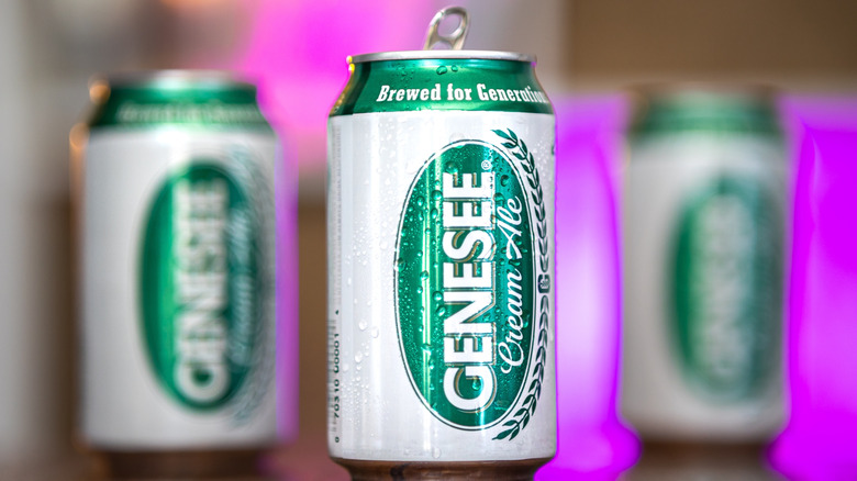A close up shot of a can of Genesee Cream Ale with other cans shown in a blurred background