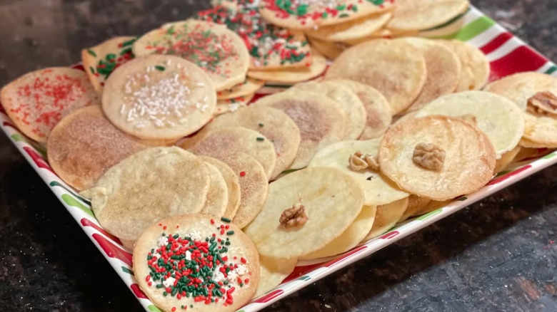 a plate of sand tarts decorated with sprinkles