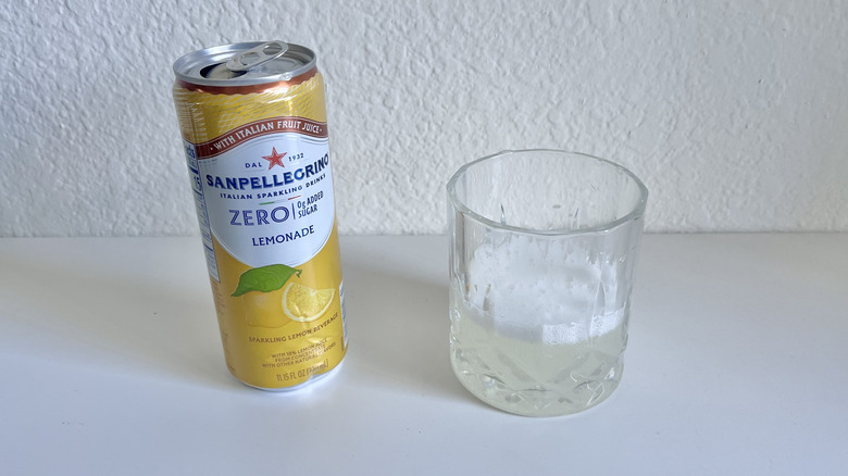 Open can of Lemonade Zero Sugar Sparkling Drink with a filled glass on the side