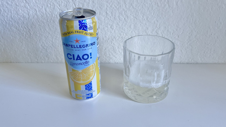 Ciao Limoncello Sparkling Water can and glass on a white counter