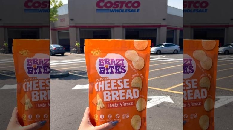 A hand holding up a packet of Brazi Bites outside a Costco store