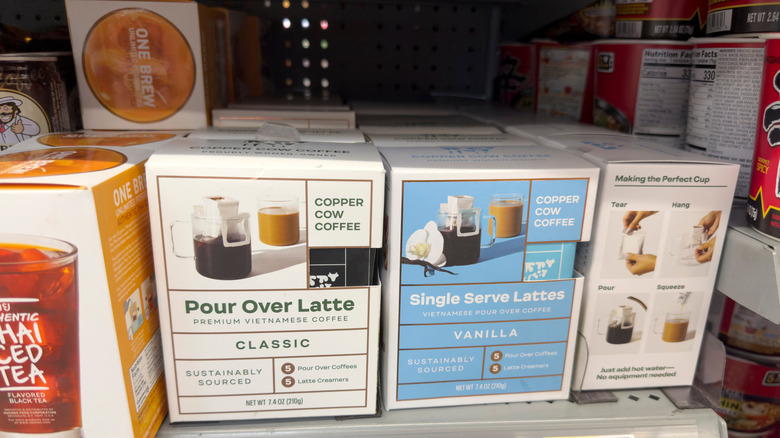 Several boxes of Copper Cow Coffee on display at a store