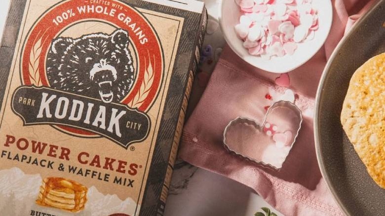 A box of Kodiak Cakes Flapjack and Waffle Mix placed next to assorted baking supplies