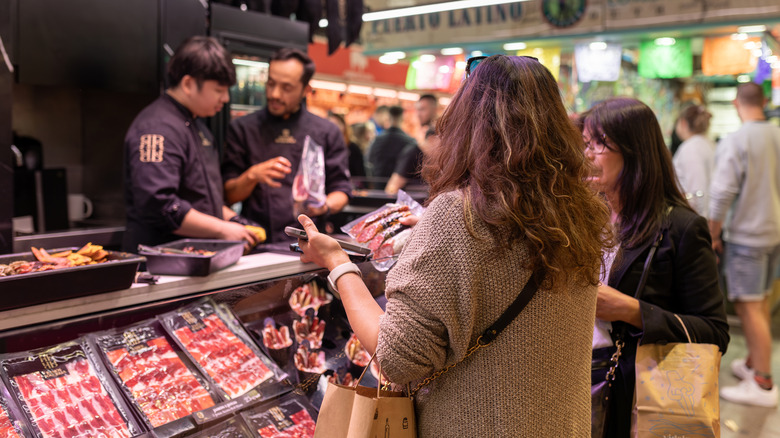Butcher shop busy with customers.