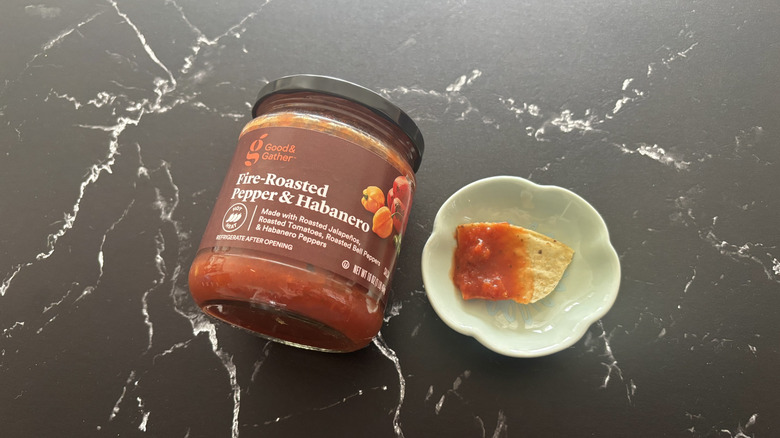 Target Good & Gather salsa next to chip with salsa on plate