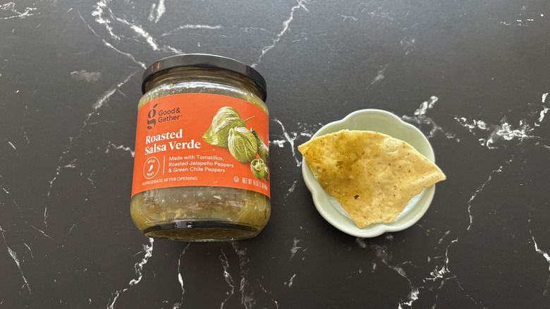 Target Good & Gather salsa verde jar next to chip with salsa on plate