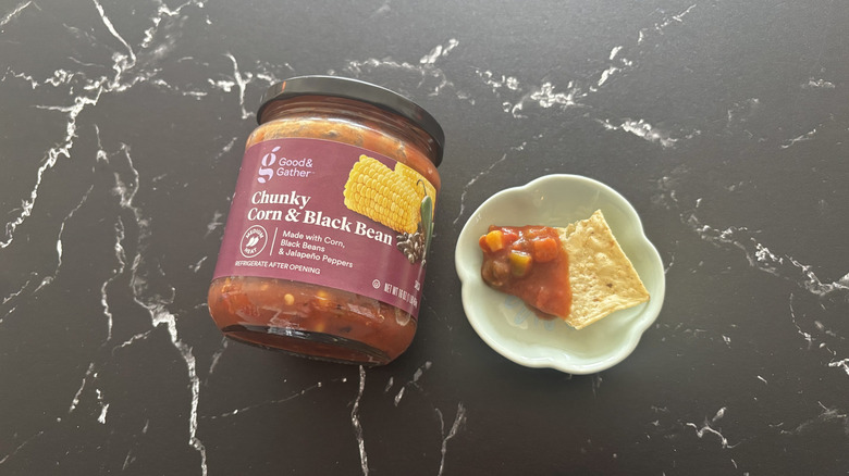 Target Good & Gather salsa next to chip with salsa on plate