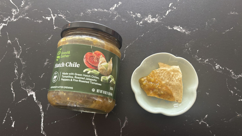 Target Good & Gather hatch chile salsa jar next to chip with salsa on plate