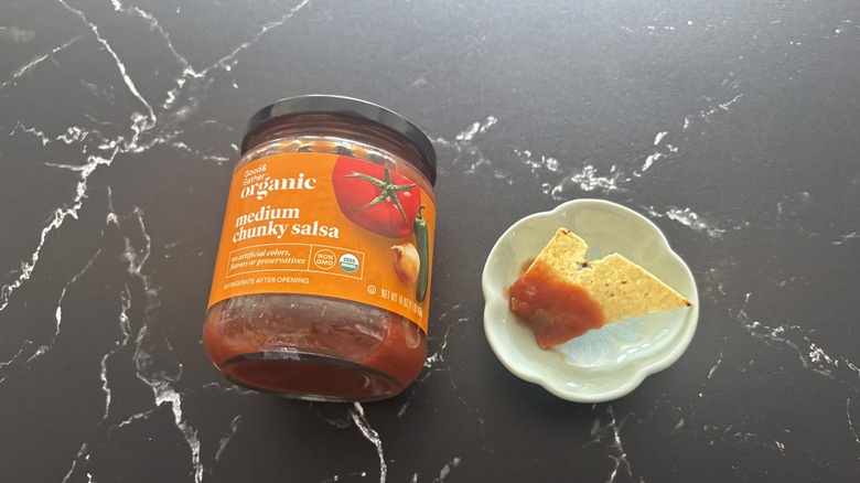 Target Good & Gather medium chunky salsa jar next to chip with salsa on plate