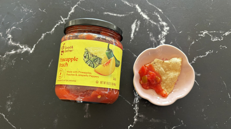 Target Good & Gather pineapple salsa jar next to chip with salsa on plate