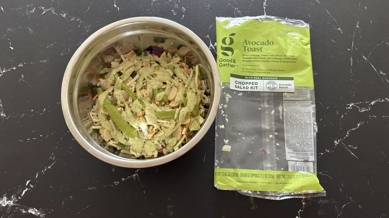 Avocado toast salad next to salad bag