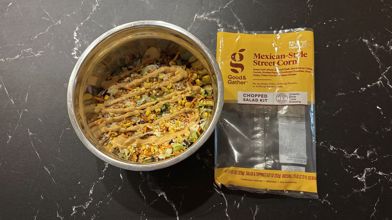 Mexican-style corn salad next to salad bag