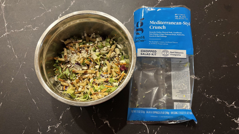 Mediterranean salad in bowl next to Mediterranean-style crunch salad