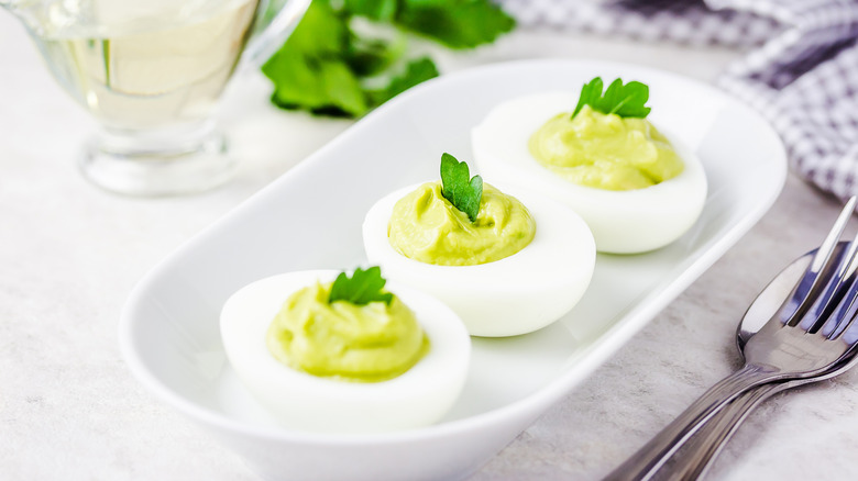 Deviled eggs on a plate with parsley