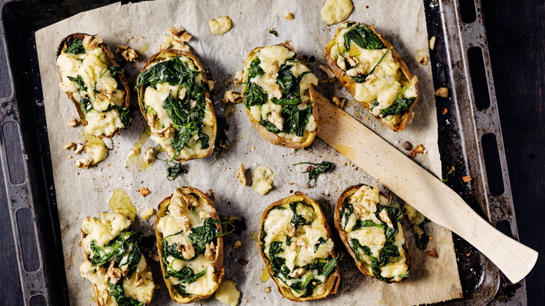 Baked potatoes with spinach and spread