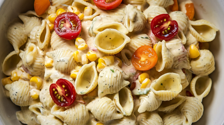 Pasta salad with corn, tomatoes, and dressing