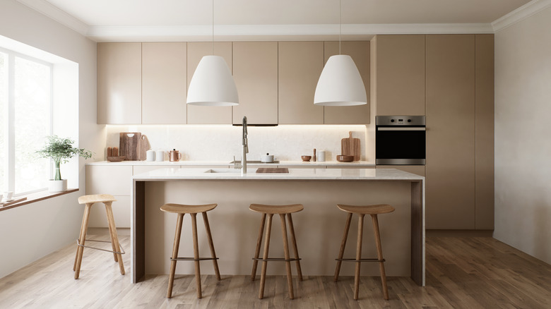 minimalist kitchen with warm toned beige cabinets