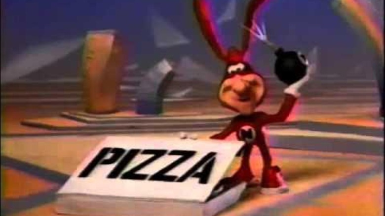screenshot of the Noid from the Domino's commercials putting a bomb in a pizza box