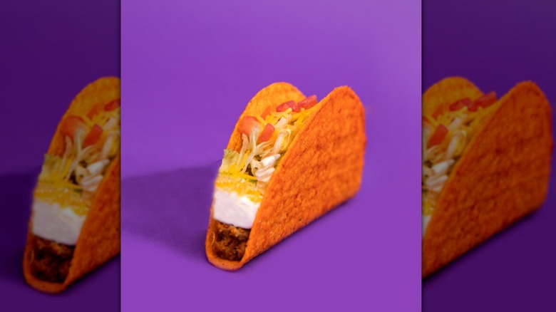 red taco bell taco against purple background mirrored
