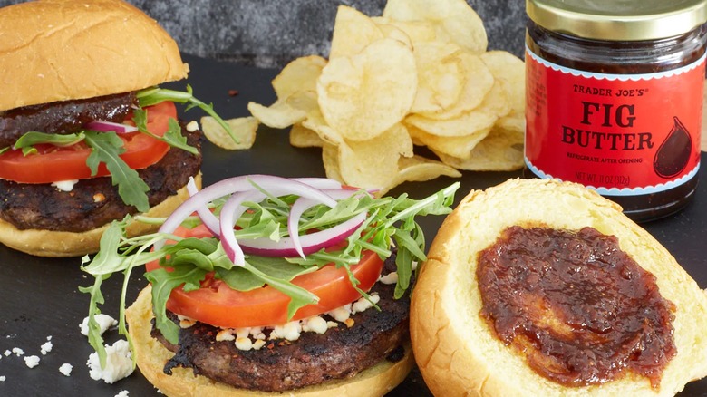 Burgers topped with Trader Joe's Fig Butter with potato chips in the background