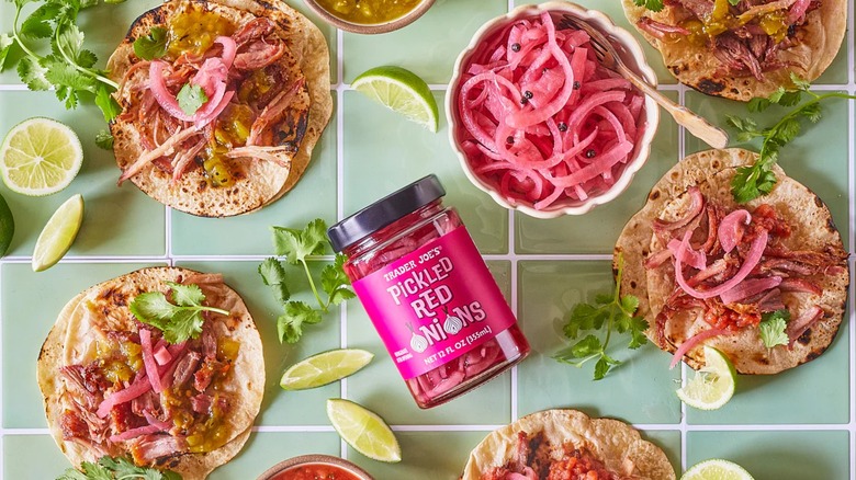 Trader Joe's Pickled Red Onions surrounded by bread buns topped with them