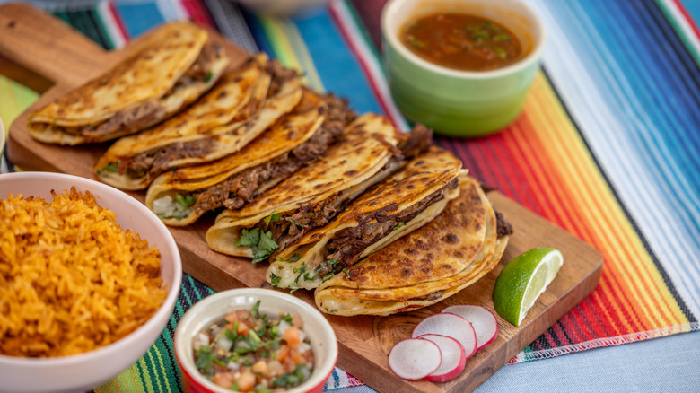 birria tacos on wooden board
