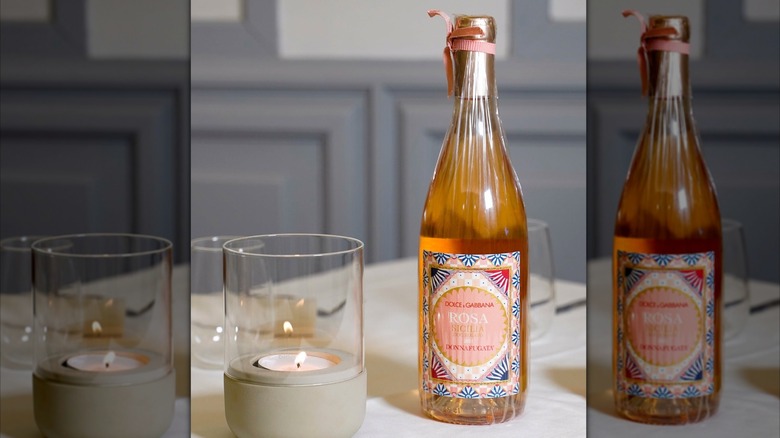 bottle of rose wine with candle
