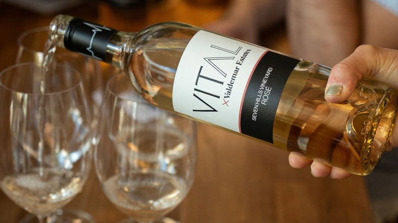 pouring rosé wine into glasses