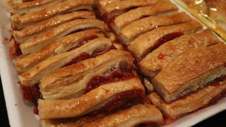 A tray of baked guava pastelitos cut into strips