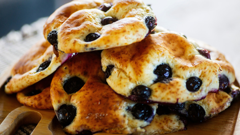 A pile of cottage cheese cookies on a wooden board