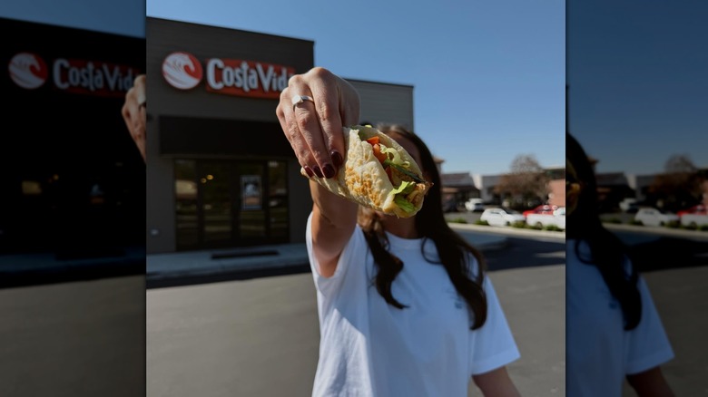 A taco being held in the air