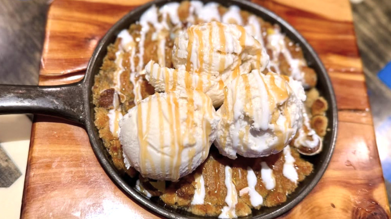 Skillet cookie with ice cream on a wooden table
