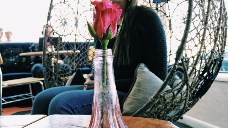 The Crepery interior with rose in a vase