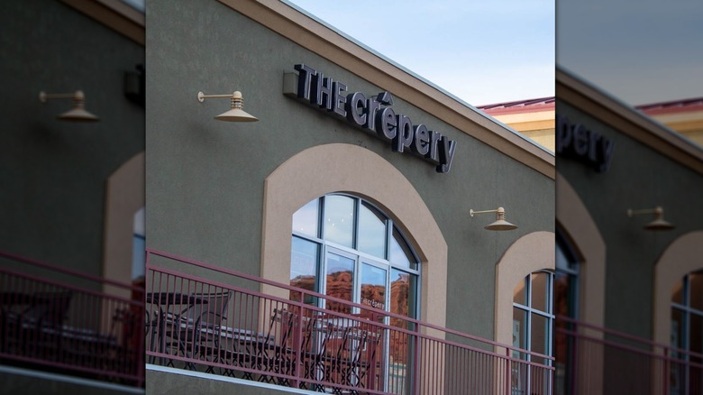 A building exterior with a sign that reads "crepery"