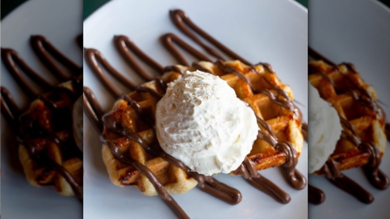 A waffle covered in whipped cream