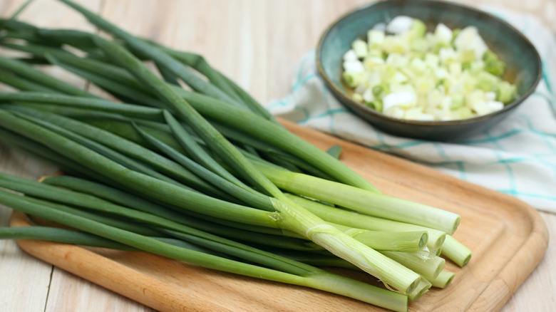 green onions on chopping board