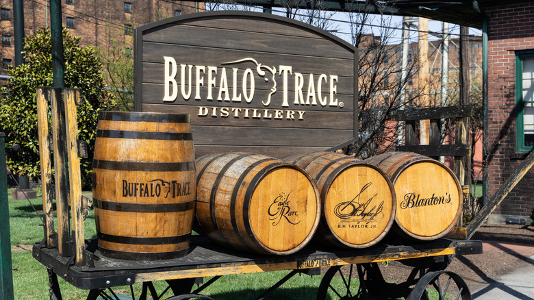A cart outside of the Buffalo Trace distillery showcasing some of the brands on branded barrels