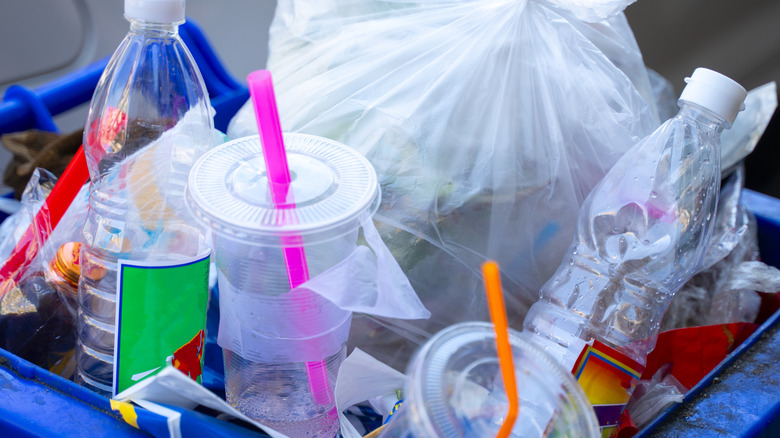 Plastic waste in blue recycling bin