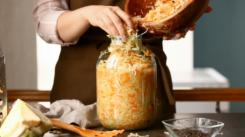 Person jarring homemade sauerkraut 