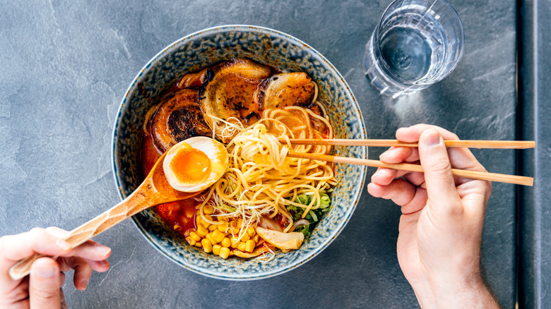 Ramen bowl with wooden spoon and chopsticks