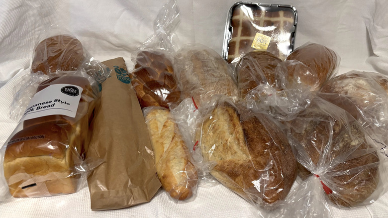 An assortment of fresh bakery breads from Whole Foods on white background