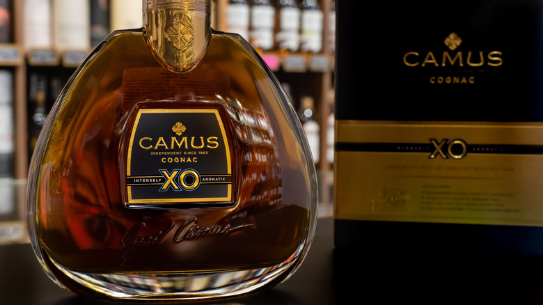 A close up of a bottle of Camus XO Elegance next to its packaging