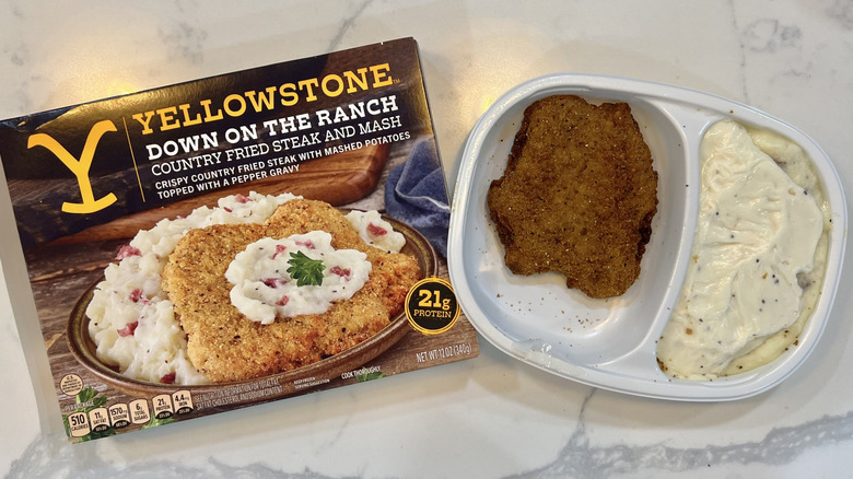 Yellowstone Down on the Ranch country fried steak and mash in tray.