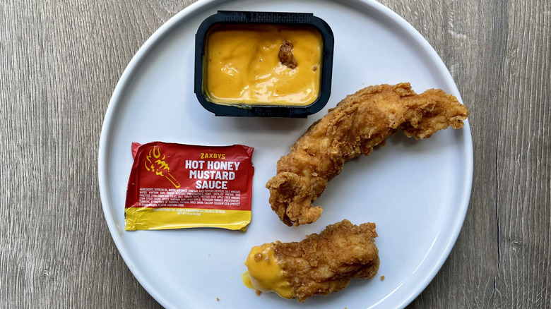 Chicken tender with hot honey mustard sauce on a plate