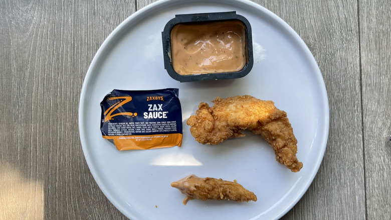 Chicken finger pieces with Zax sauce on a plate